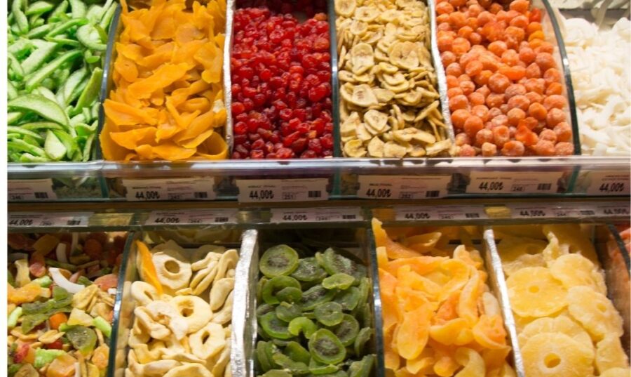 Variedad de frutas deshidratadas exhibidas en un mercado.